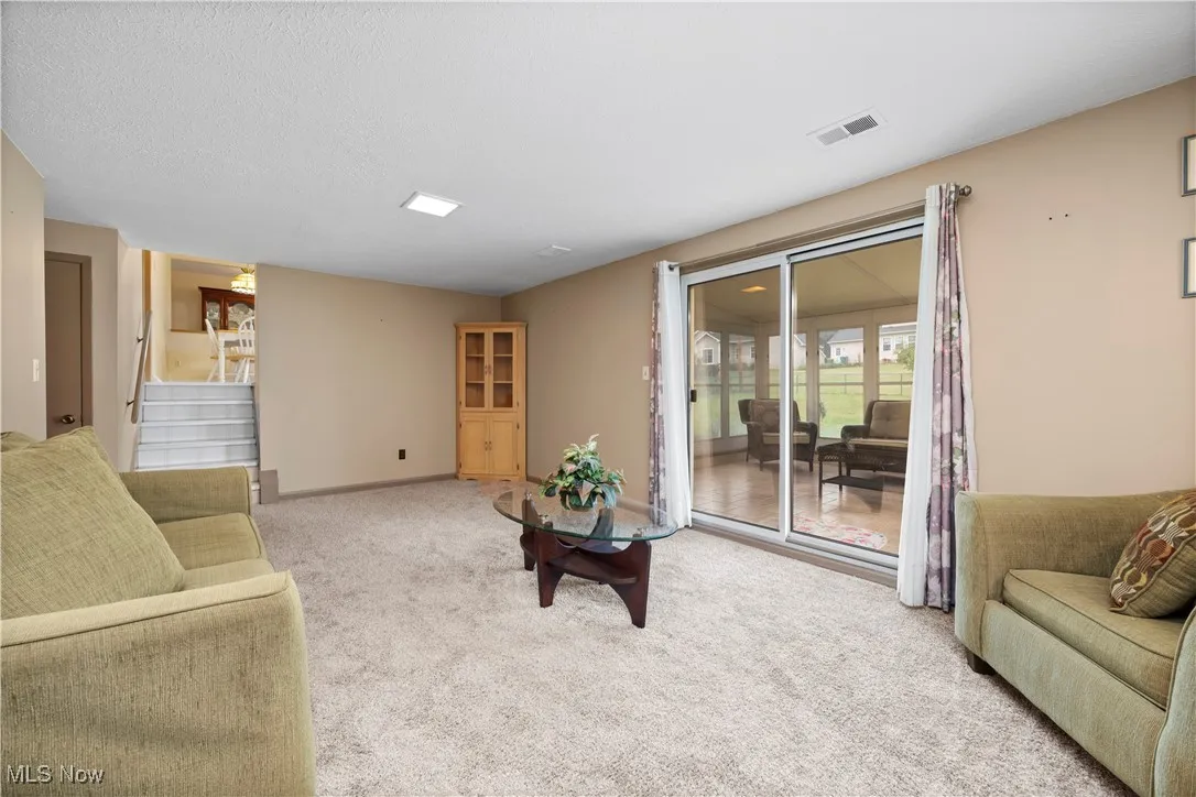 FAMILY room featuring light carpet