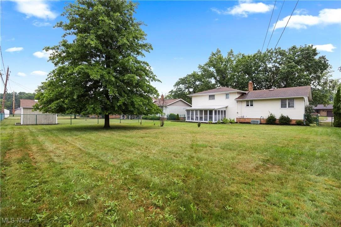 View of yard featuring a sunroom