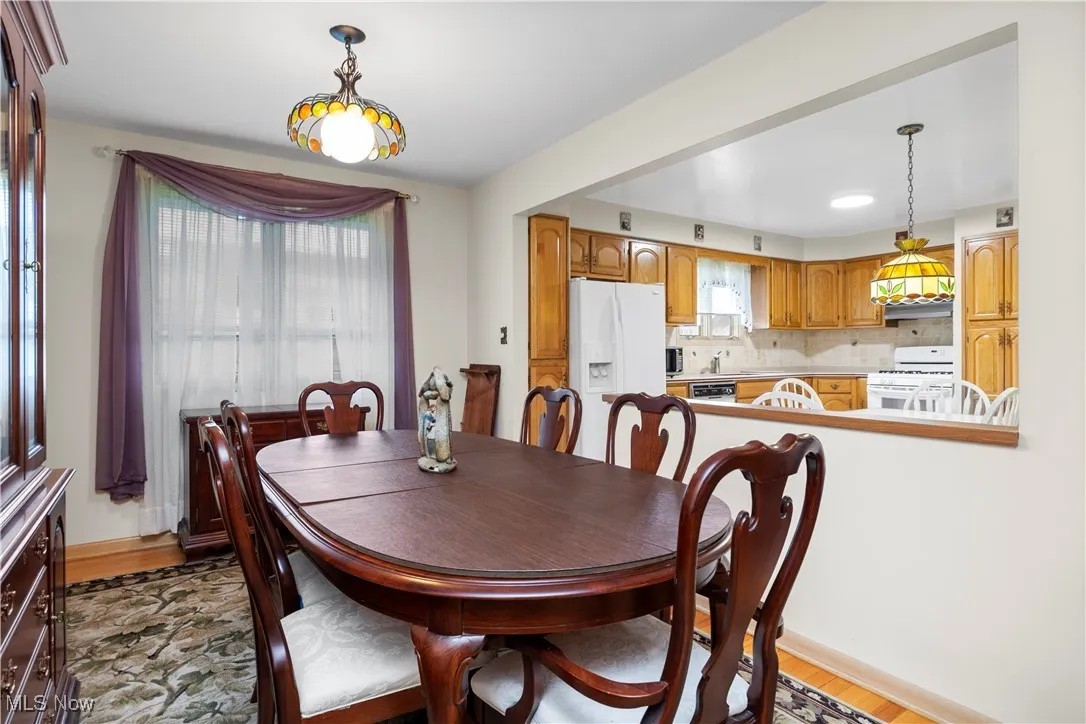 Dining space with wood finished floors and recessed lighting
