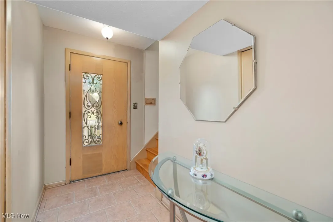 Foyer with baseboards and stairway