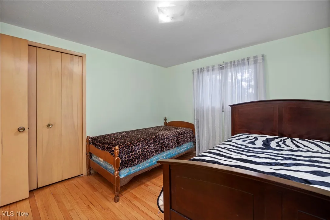 Bedroom featuring light wood finished floors and a closet