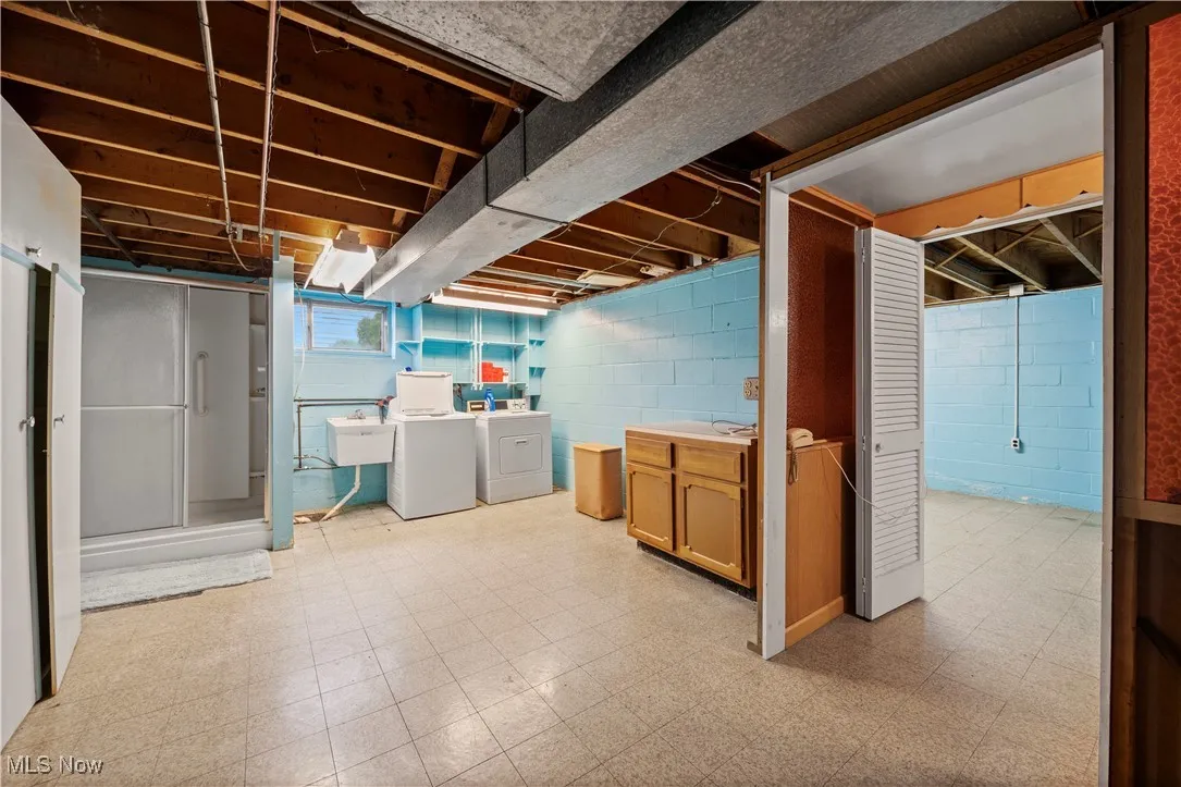 Below grade area featuring light floors and separate washer and dryer