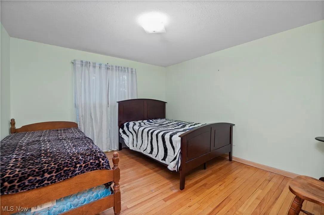 Bedroom with light wood-type flooring and baseboards