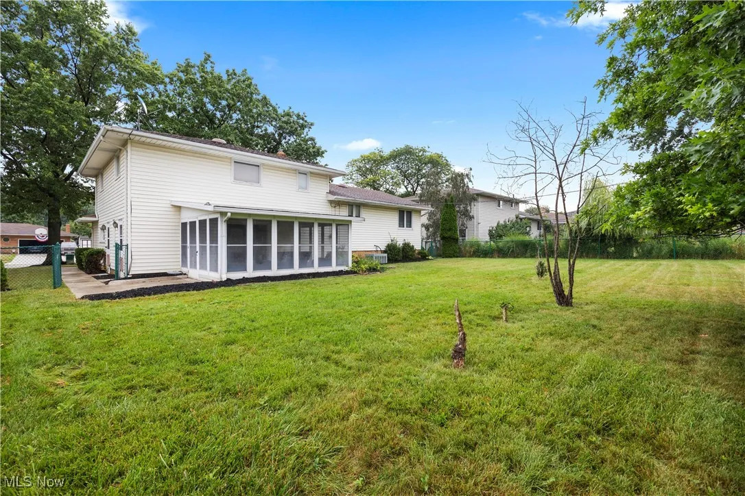 Rear view of house featuring a sunroom