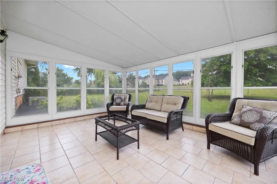Sunroom / solarium featuring vaulted ceiling and outdoor lounge area