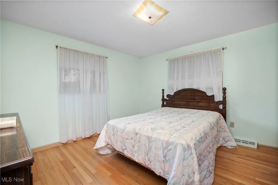 Bedroom featuring light wood-type flooring and baseboards