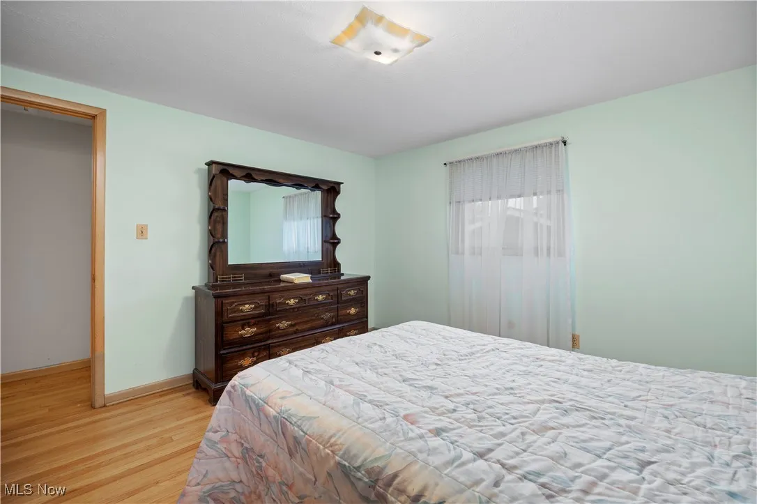 Bedroom with light wood-style floors and baseboards