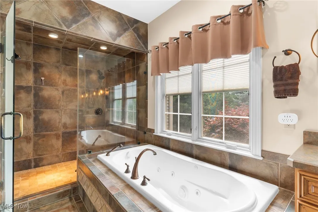 Spa inspired Bathroom with a stall shower and a tub with jets