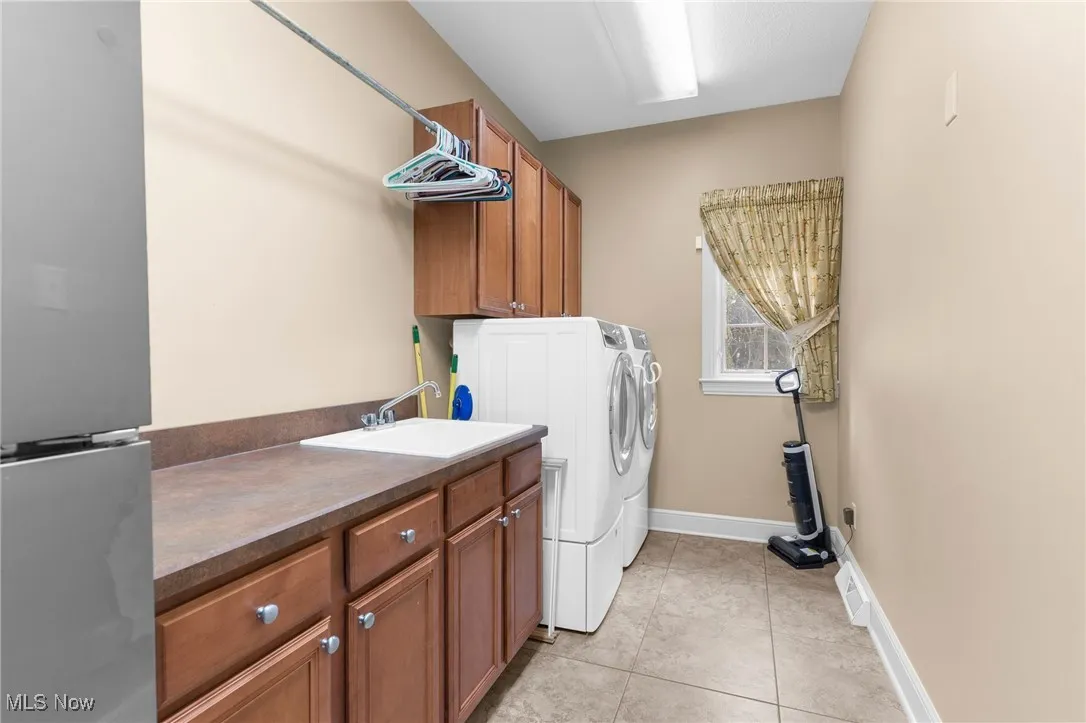 Laundry room main floor, featuring cabinet space, gas hookup