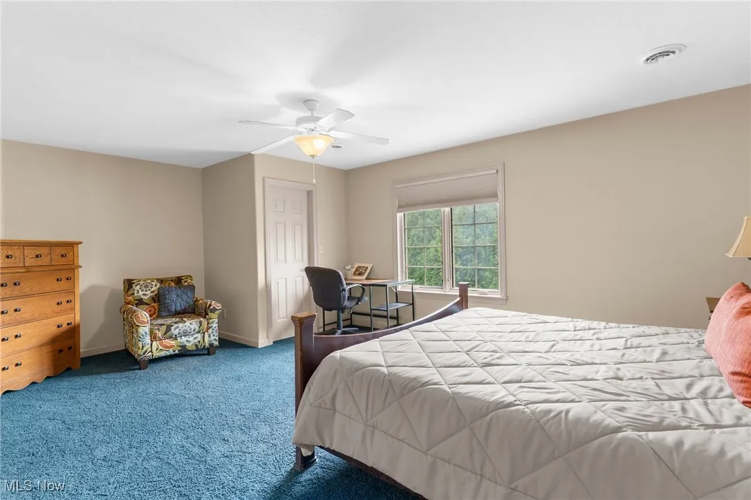 Bedroom with ceiling fan and closet