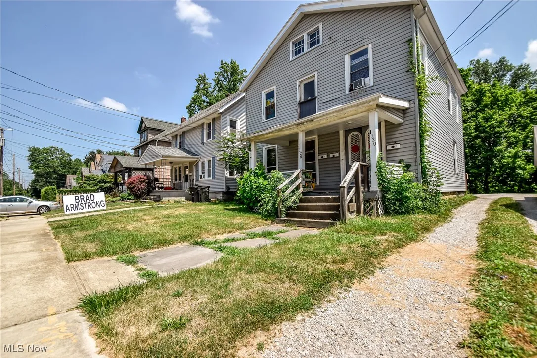 Traditional style home with a porch and a front lawn