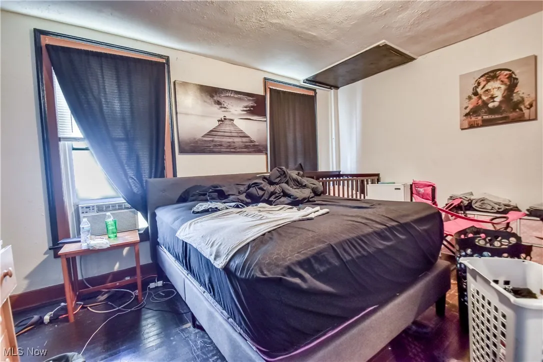Bedroom featuring wood finished floors and a textured ceiling