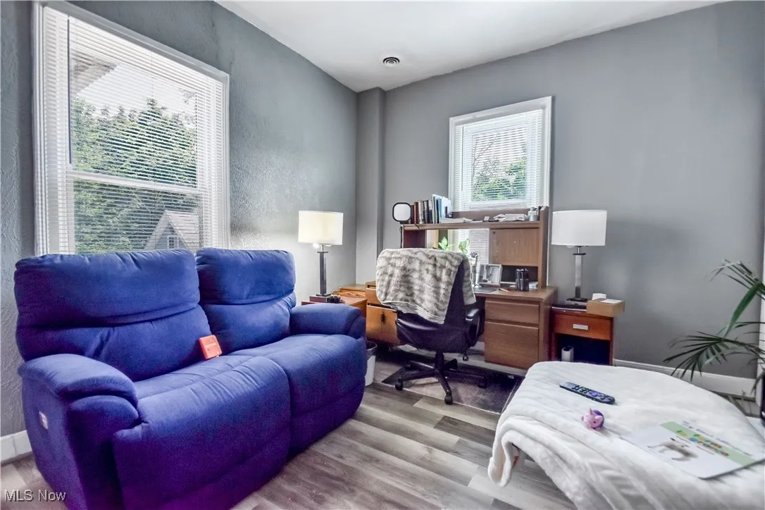 Office space featuring wood finished floors and a textured wall