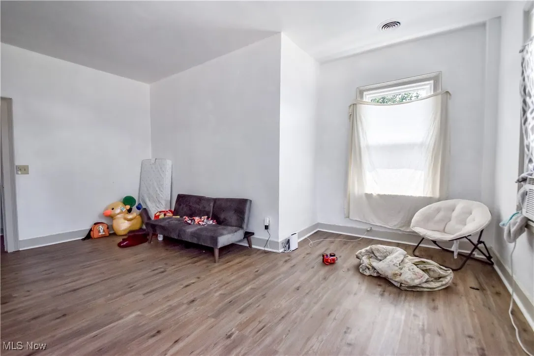 Unfurnished room featuring wood finished floors and baseboards