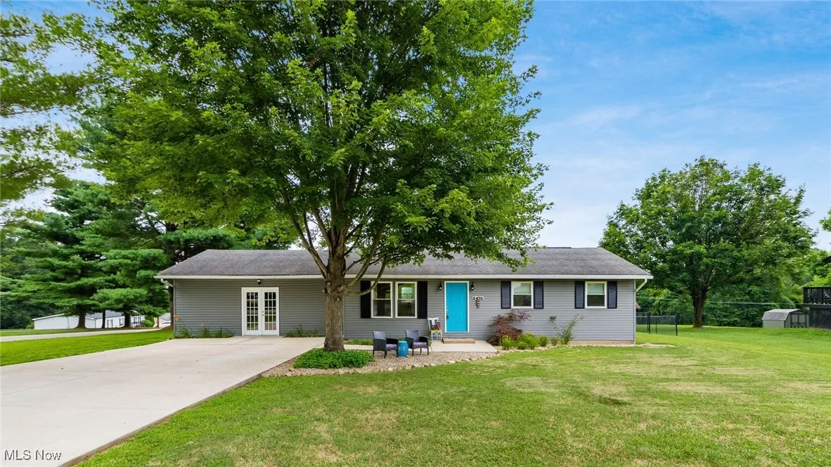 Ranch-style home with french doors and driveway