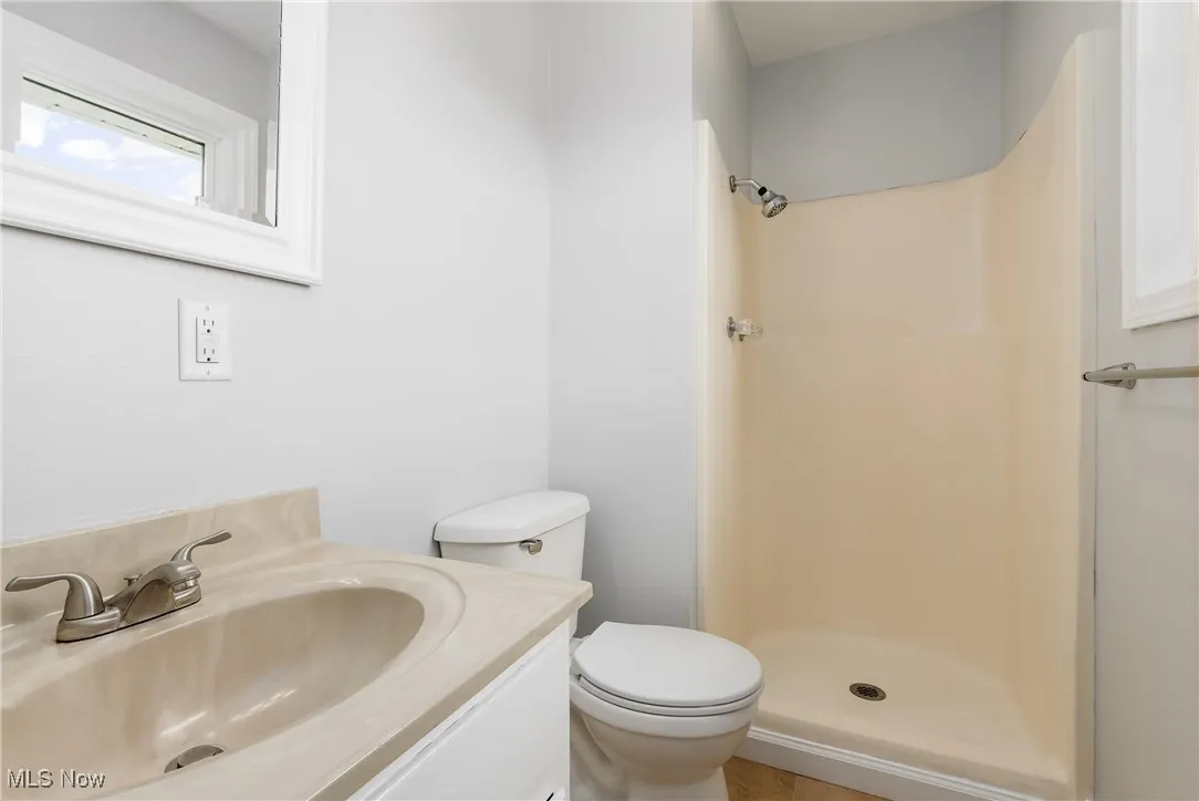 Full bath with a shower and vanity