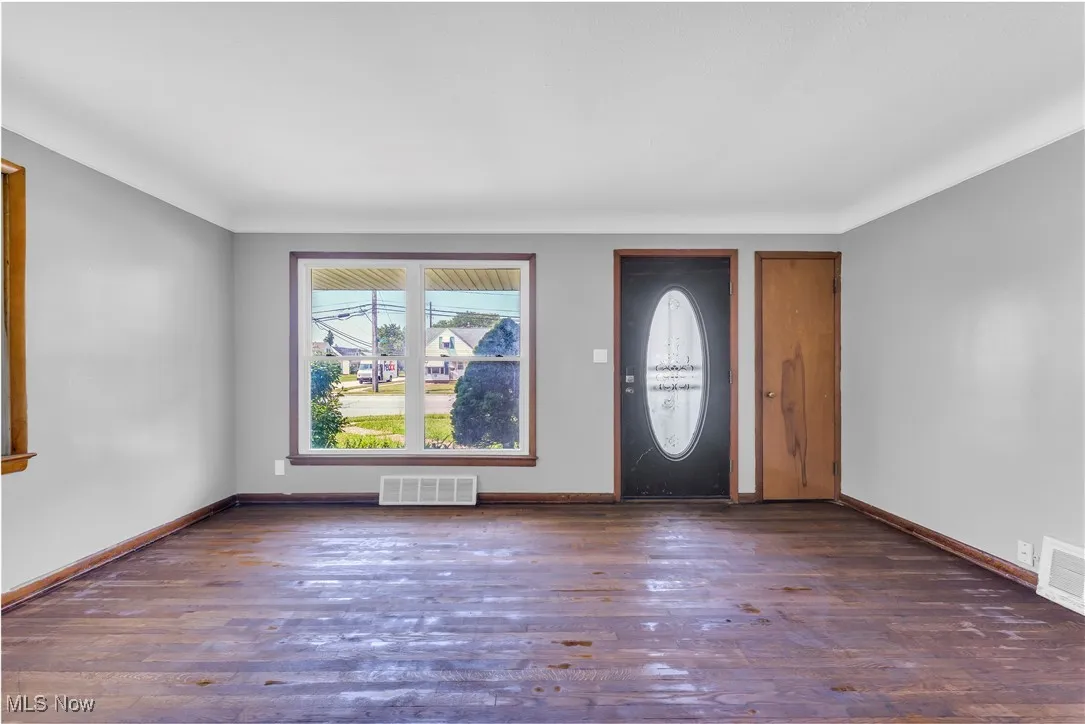 Foyer entrance featuring wood finished floors and baseboards
