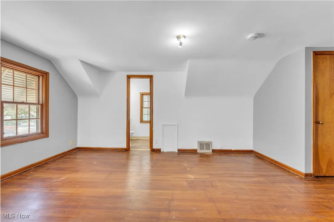 Bonus room featuring wood finished floors and lofted ceiling