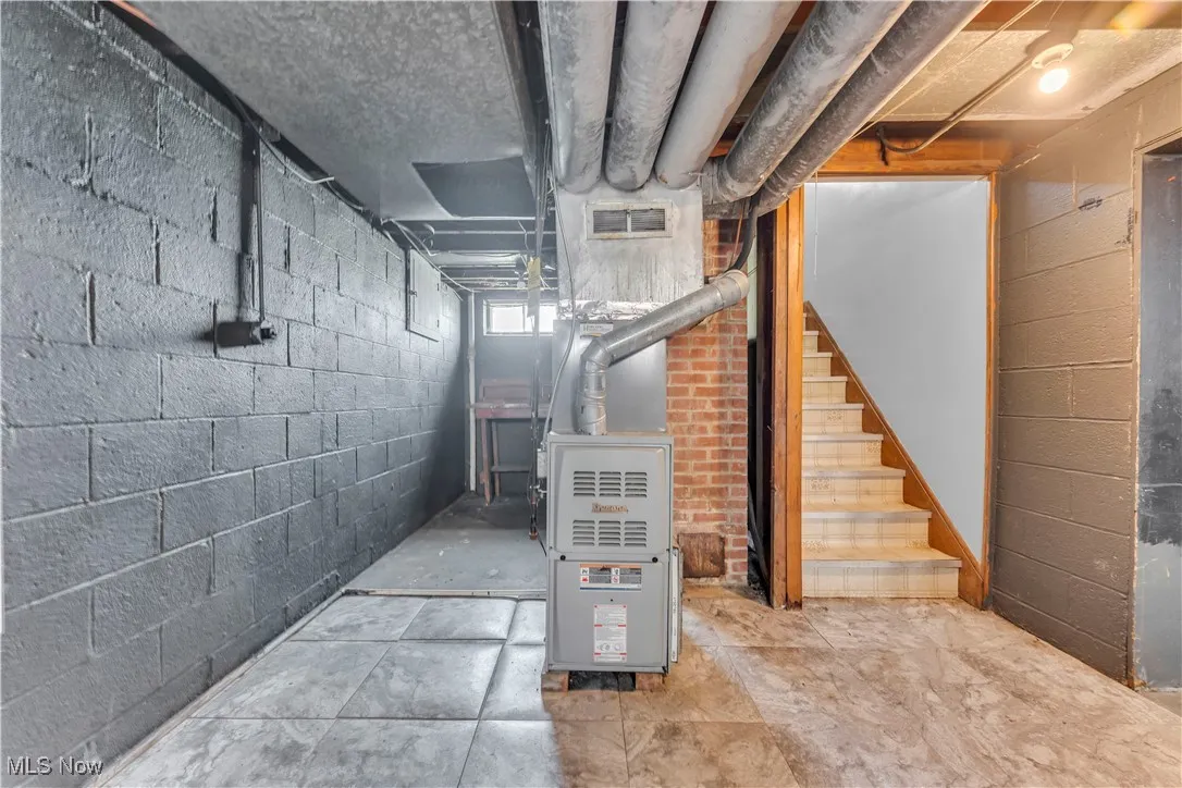 Basement with stairs and heating unit