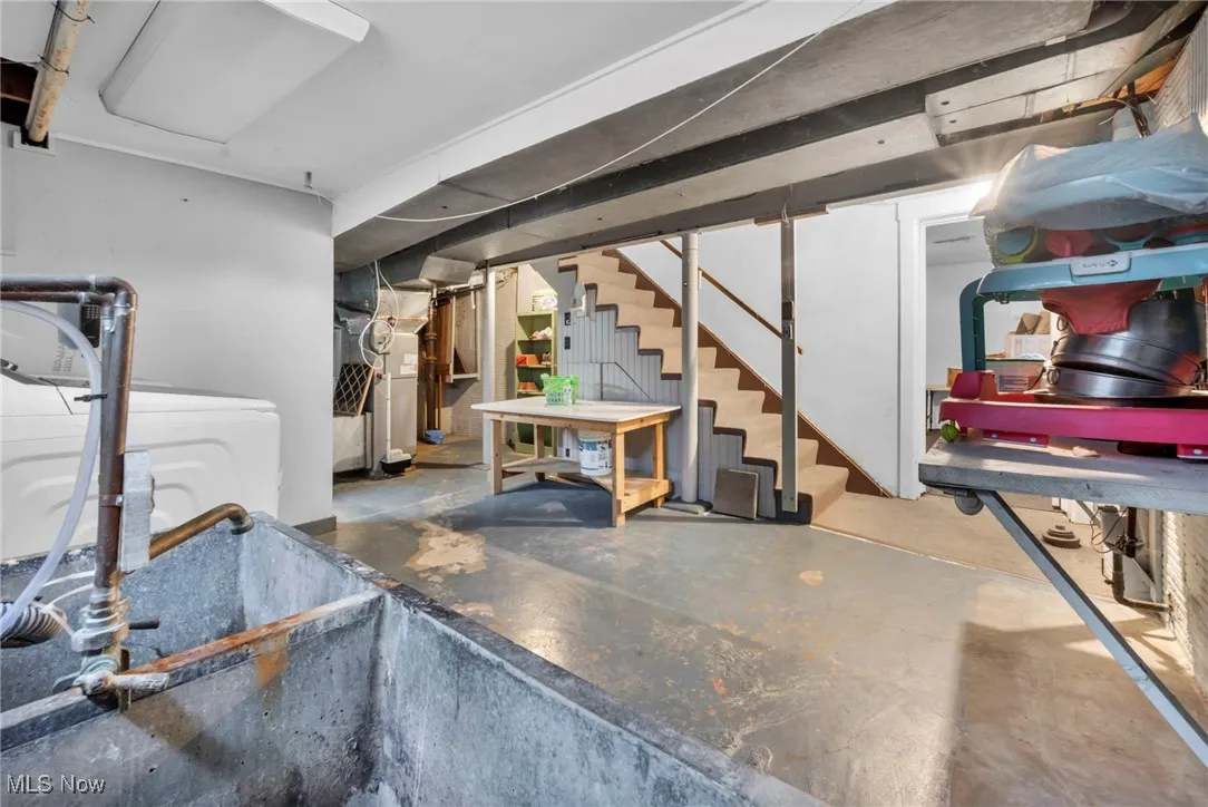 Basement with stairs, washer / clothes dryer, and heating unit