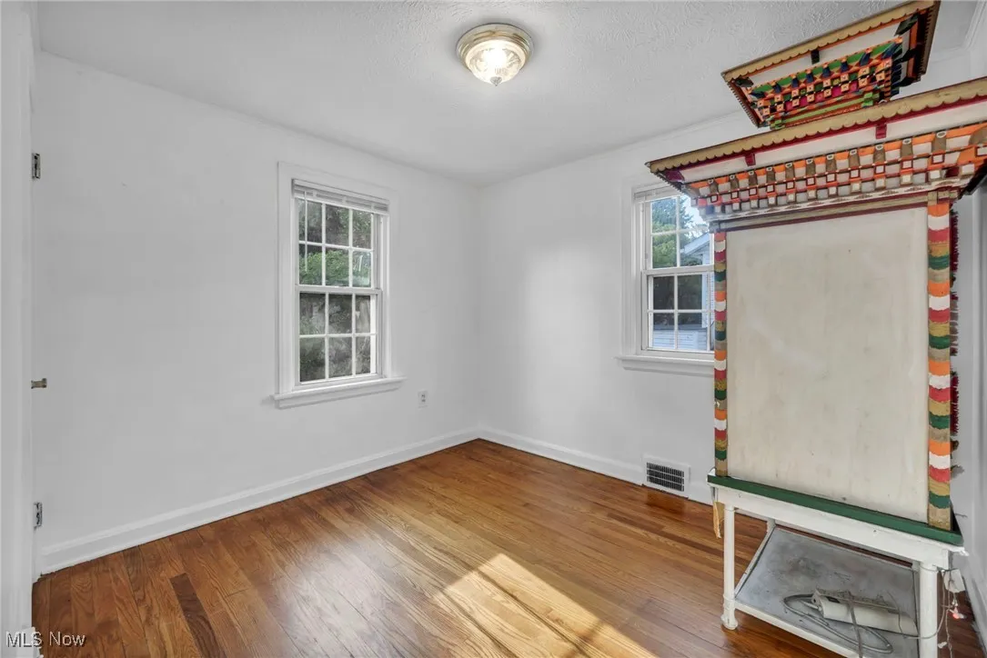 Unfurnished bedroom featuring wood finished floors and a textured ceiling