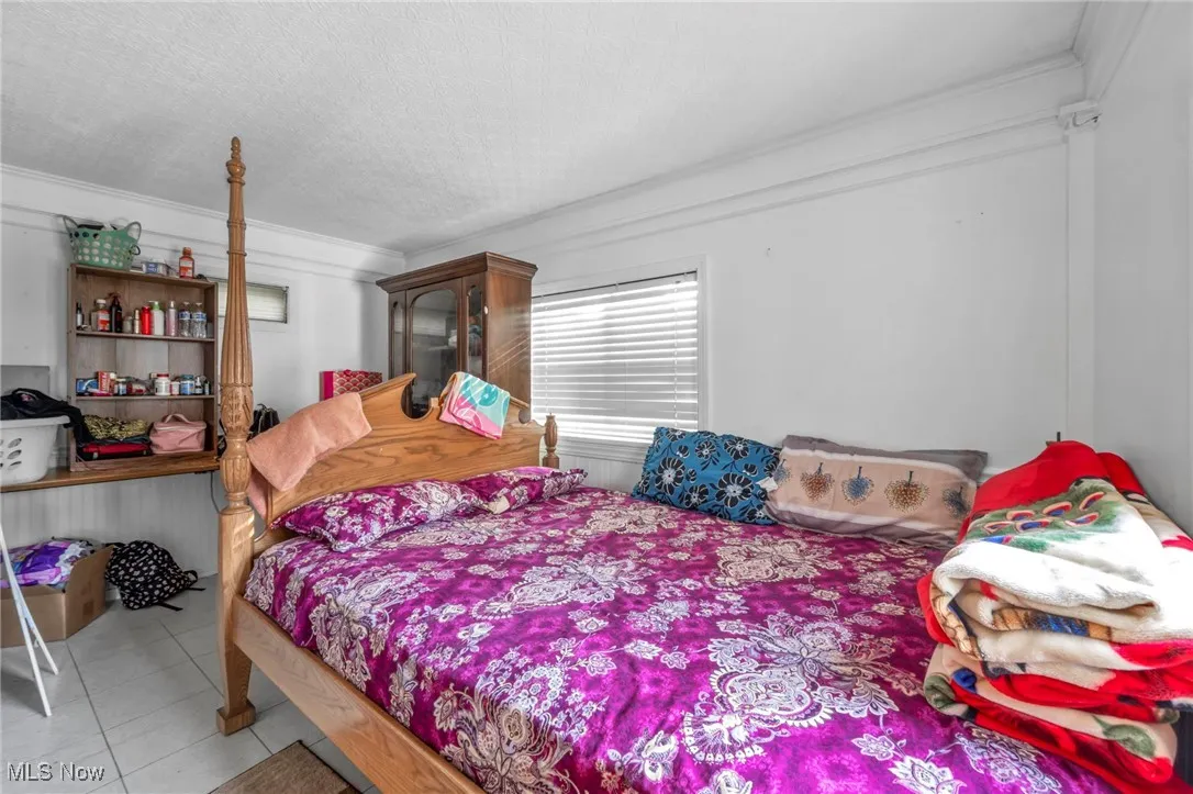 Tiled bedroom with crown molding