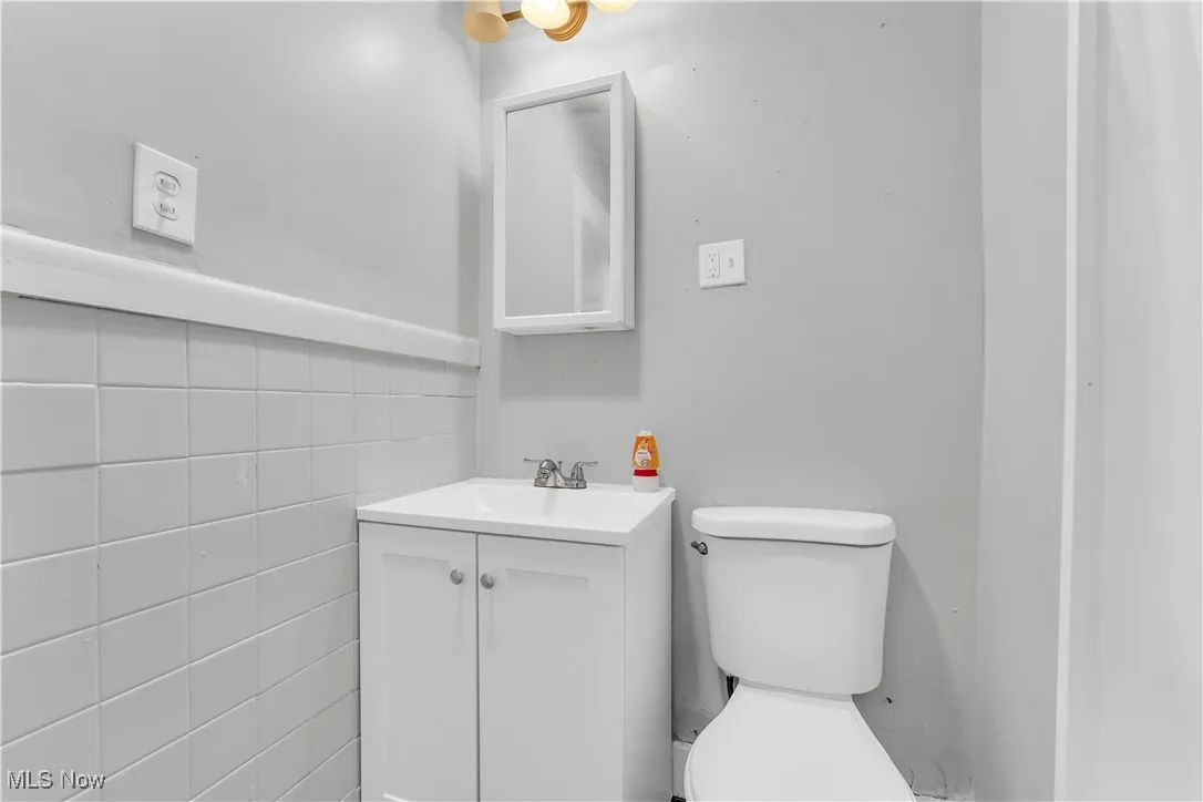 Bathroom featuring vanity and tile walls