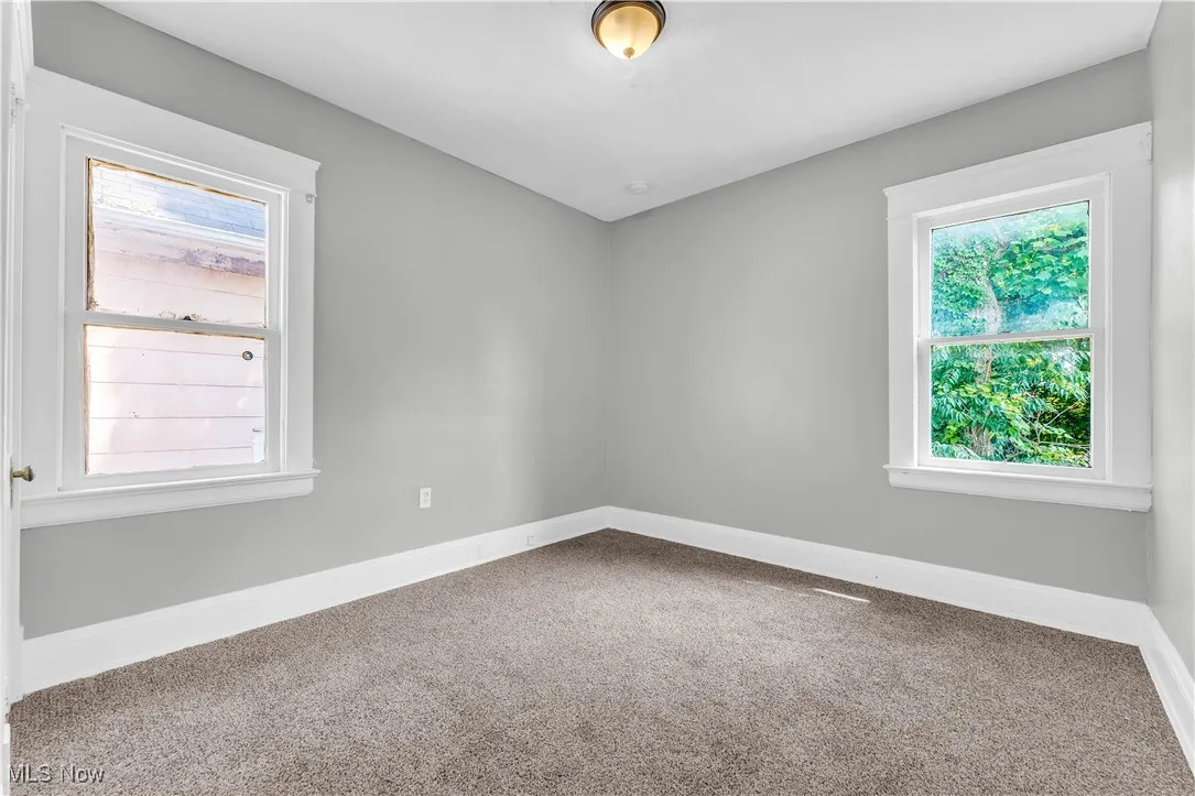 Unfurnished room with carpet and baseboards