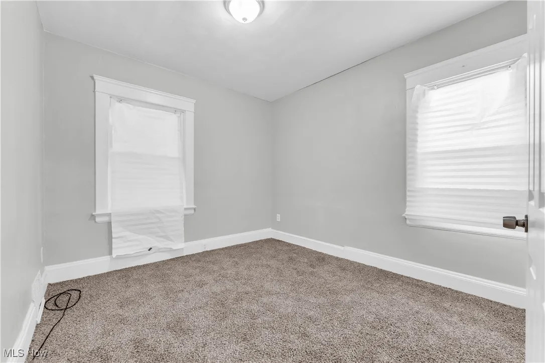 Unfurnished room featuring carpet flooring