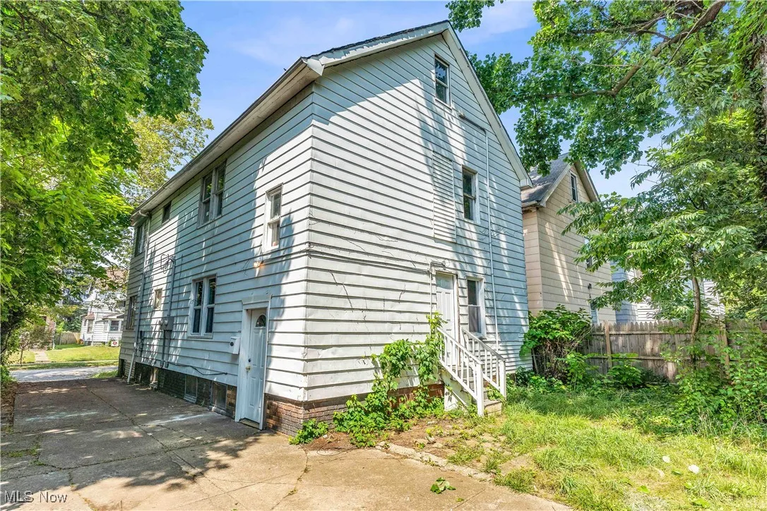 View of property exterior with concrete driveway