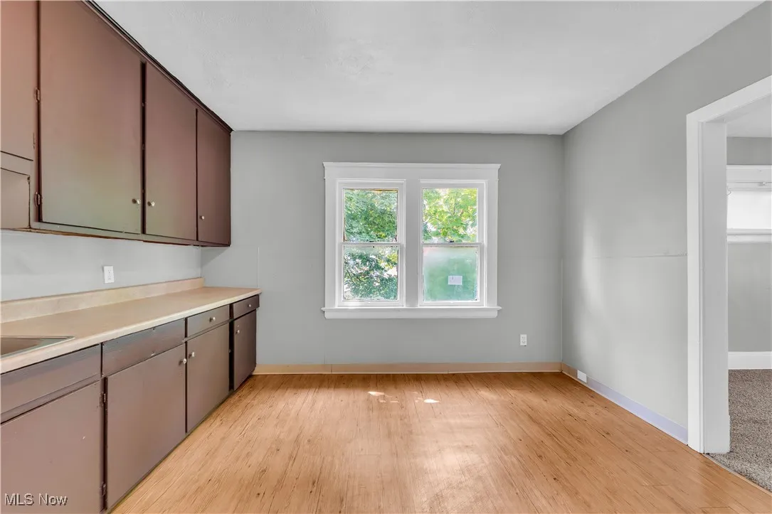 Kitchen with light wood finished floors and light countertops
