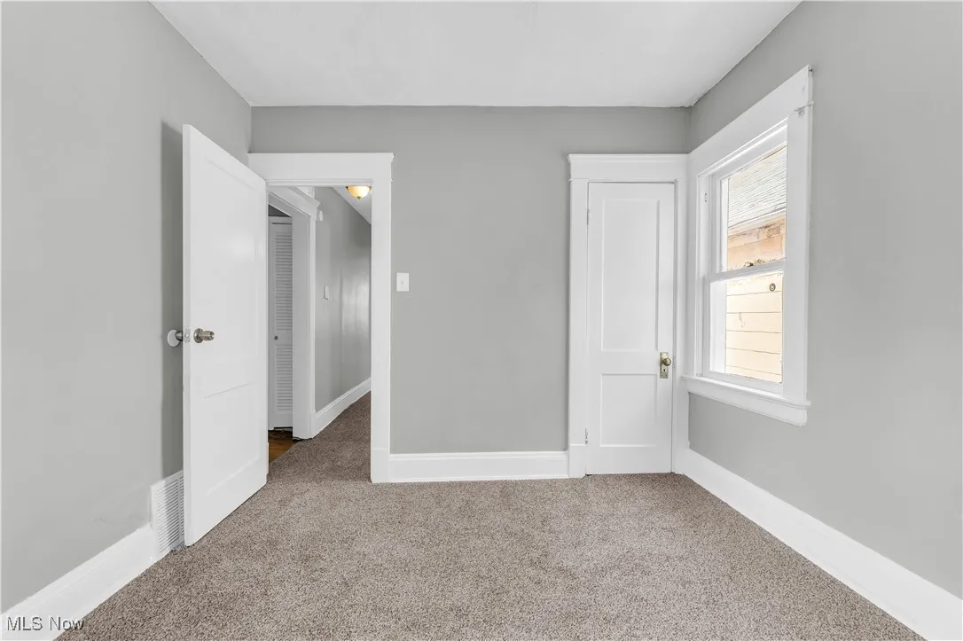Unfurnished bedroom with carpet floors