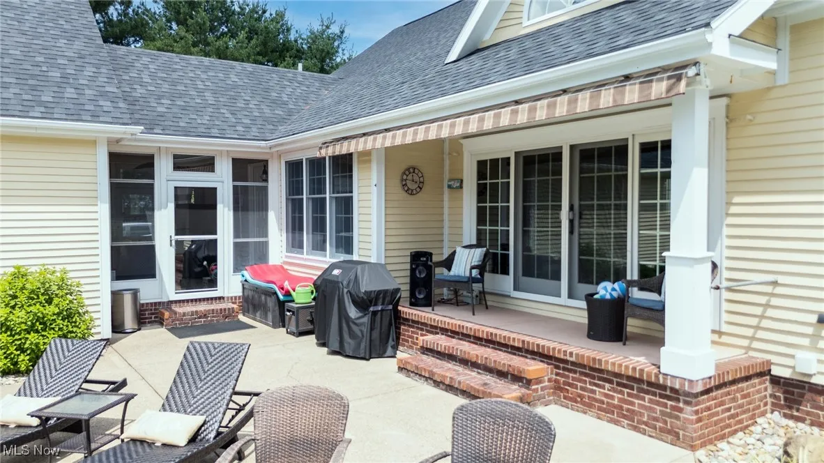 View of paver patio featuring a grill