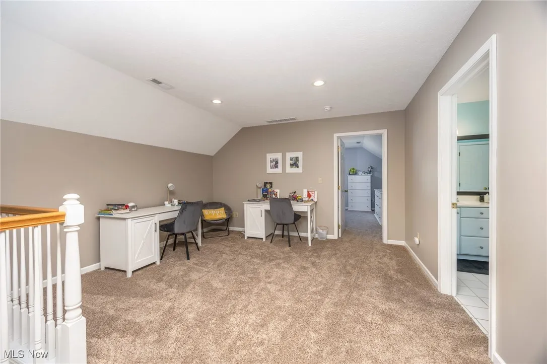 Office/loft area with light colored carpet, vaulted ceiling, and recessed lighting