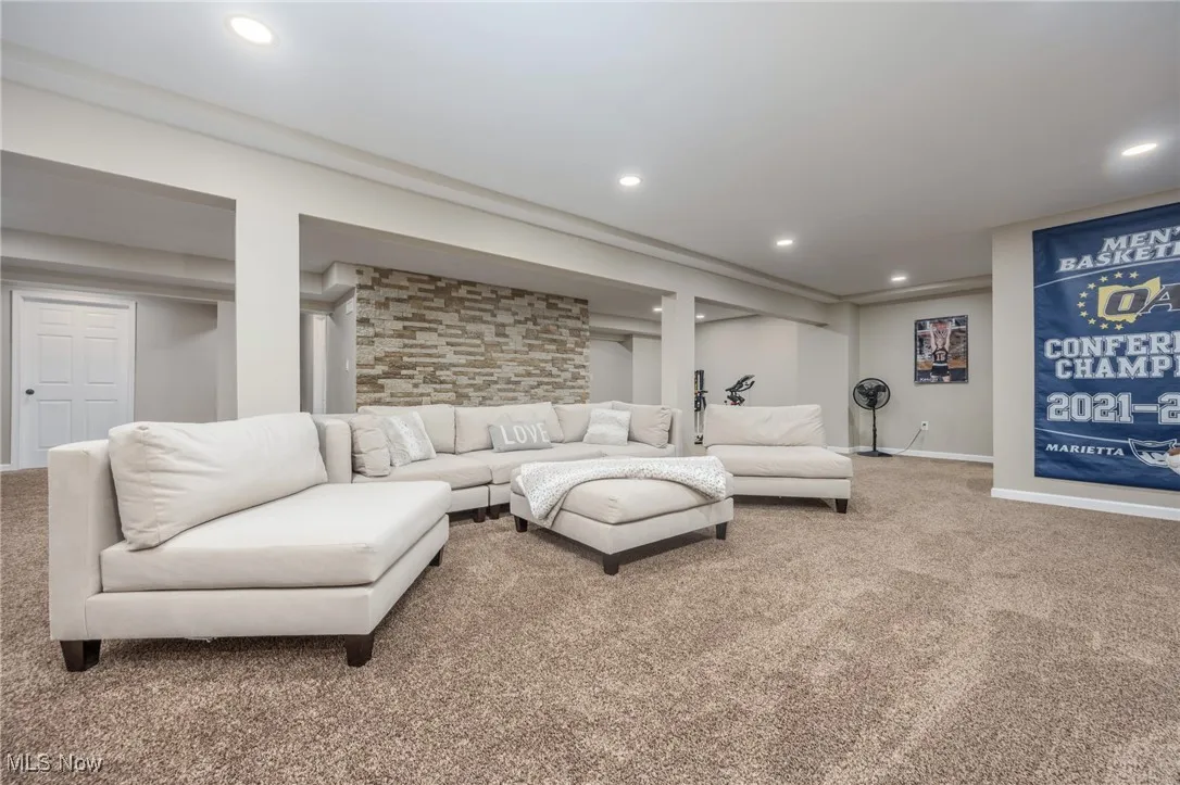 Lower-level living room with carpet floors and recessed lighting