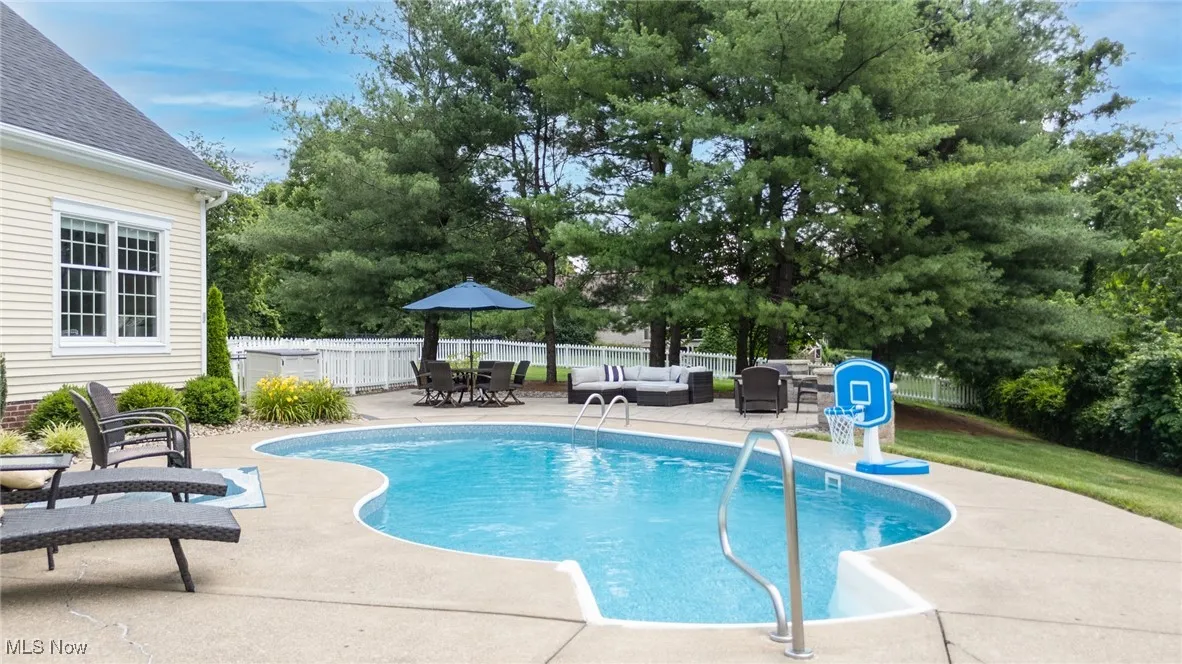 View of heated swimming pool with outdoor lounge area and a patio