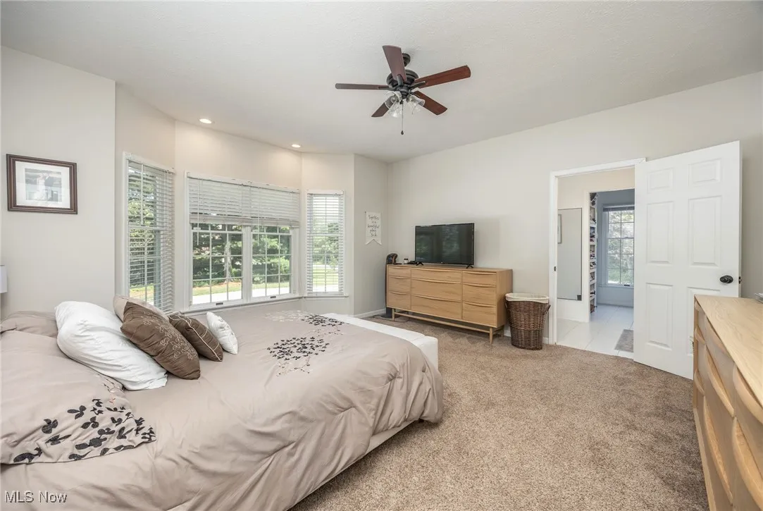 Primary bedroom featuring carpet, recessed lighting, and ceiling fan