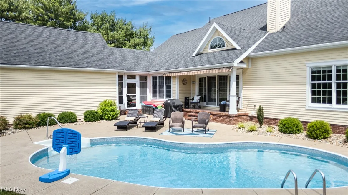 Swimming pool with a patio area, an outdoor living space, and grilling area
