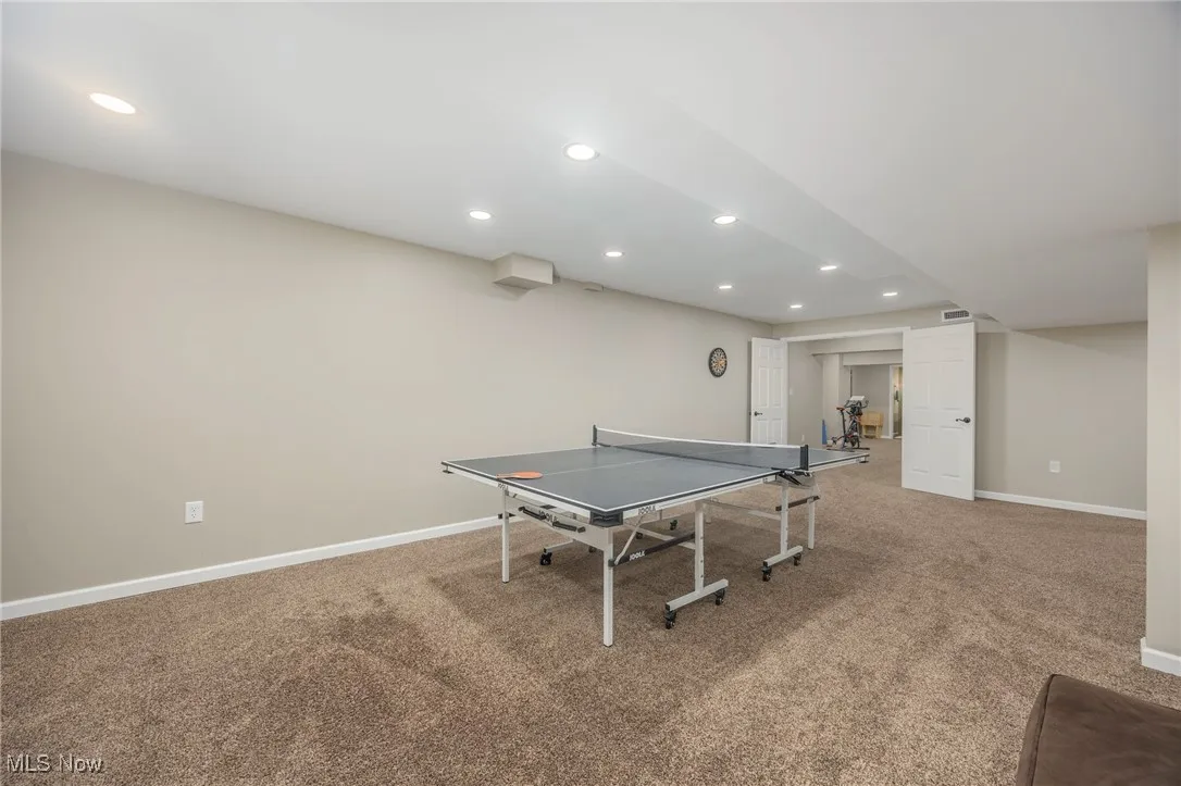 Recreation room featuring recessed lighting and carpet flooring