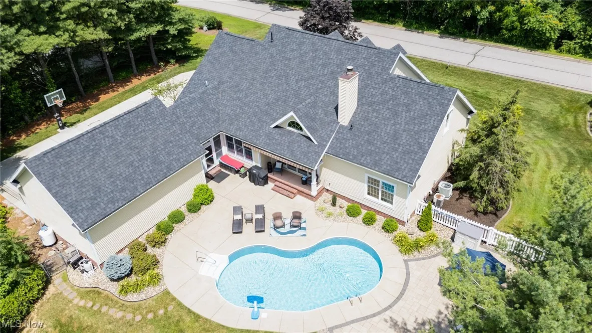 Aerial view of property and surrounding area with a pool area