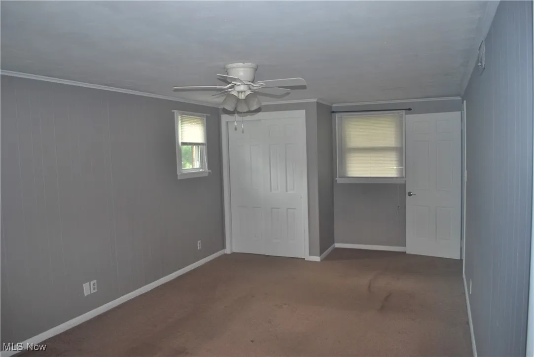 Master bedroom with two double closets and crown molding