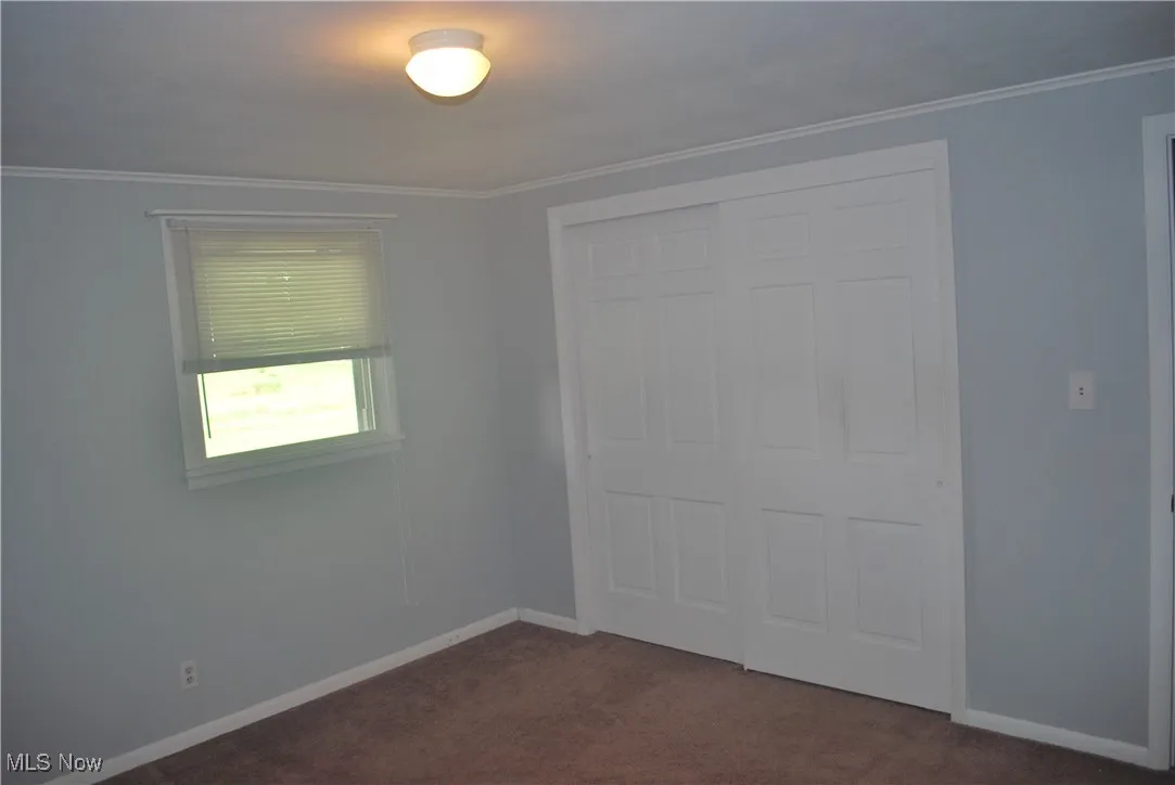 Bedroom 2 with double closet and crown molding