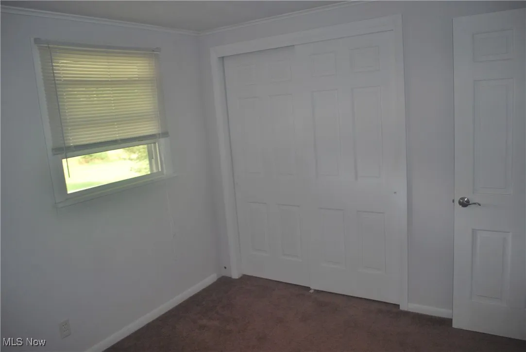 Bedroom 1 with double closet, and crown molding