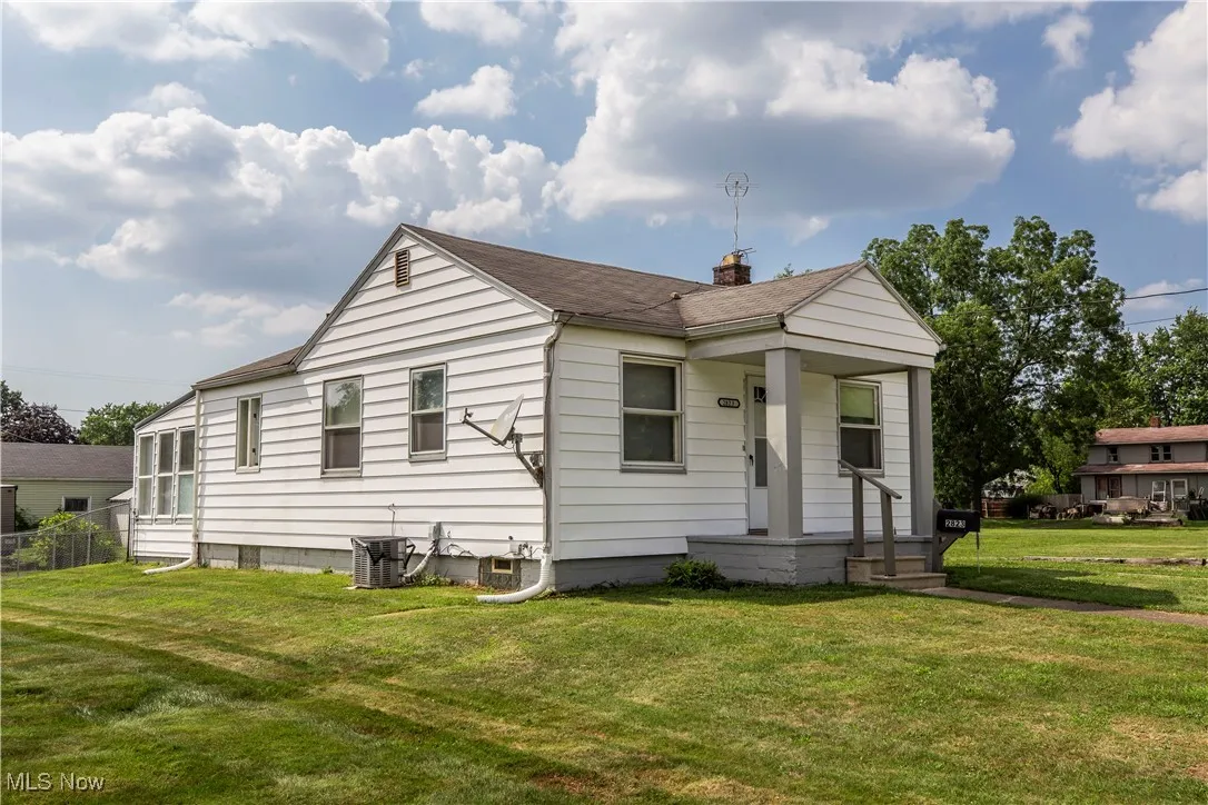 View of front of house with a chimney and a shingled roof