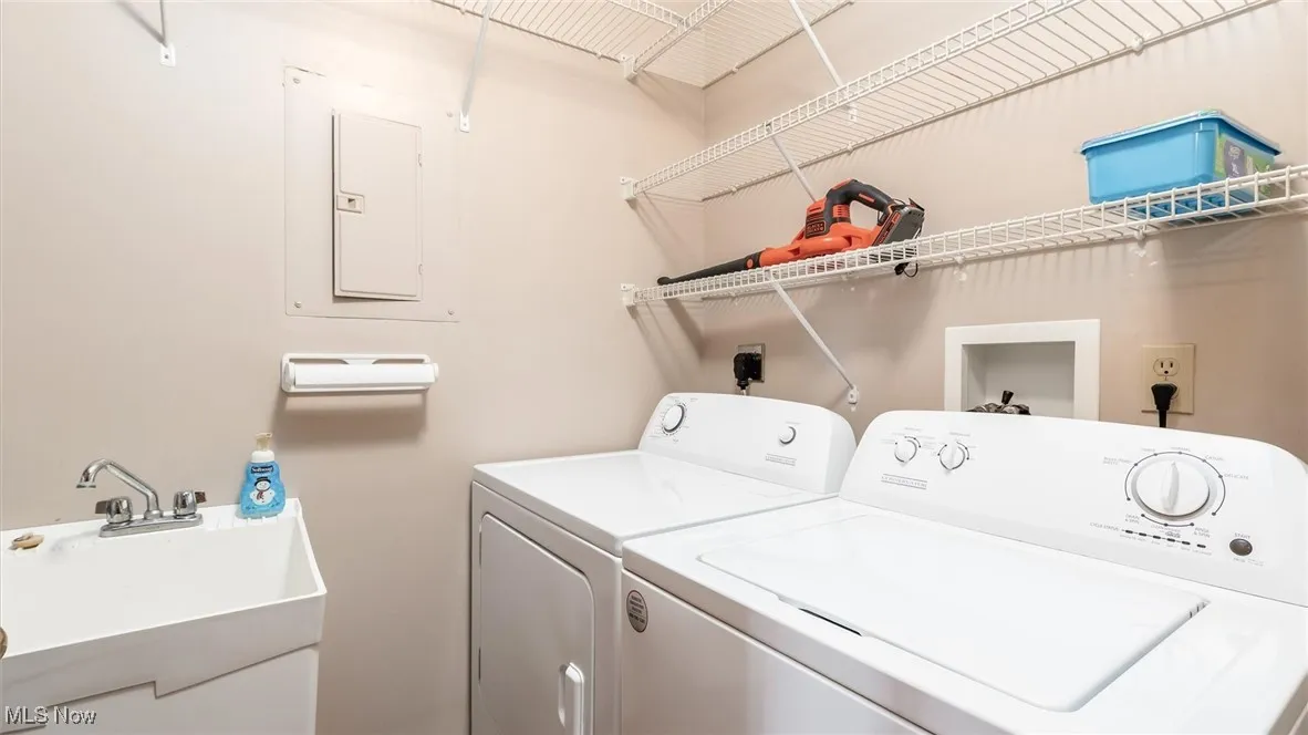 Washroom featuring washer and clothes dryer and electric panel