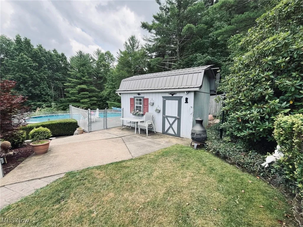 Shed with metal roof and fenced pool area.
