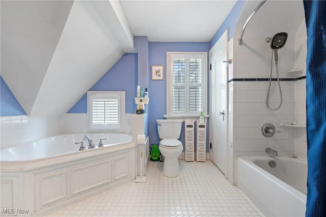 Full bath with plenty of natural light and bathtub / shower combination