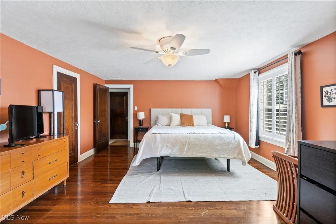 Bedroom featuring dark wood-type flooring and ceiling fan
