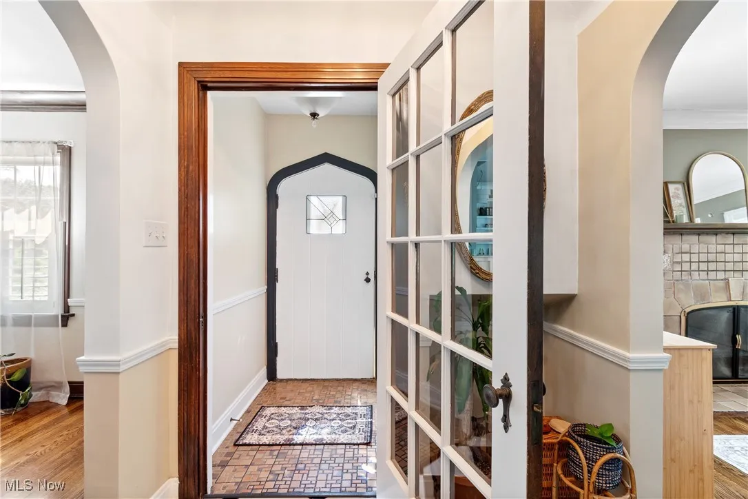 Entrance foyer with arched walkways and ornamental molding