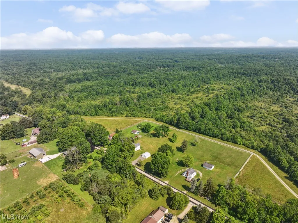Aerial overview of property's location featuring a heavily wooded area